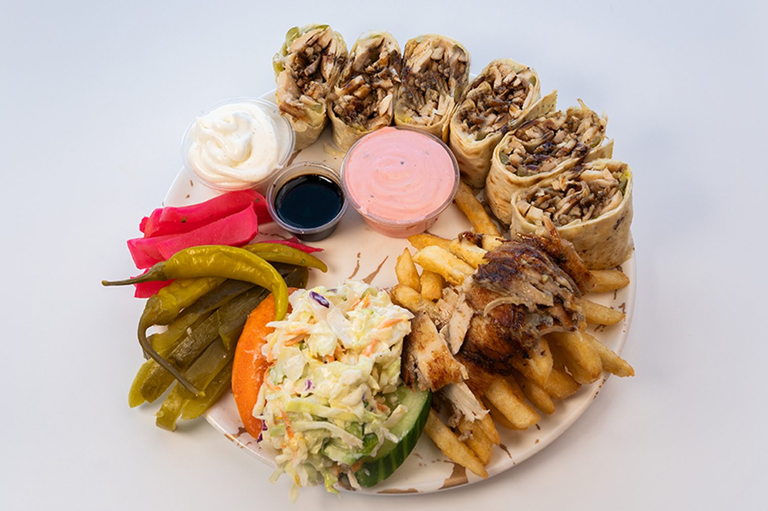 Indulge in the sumptuous flavors of Anas Turkey Shawarma Meals. Delicately spiced turkey, accompanied by pickles, tomatoes, parsley, onions, pomegranate molasses, and tahini sauce. Served with fries, coleslaw, pickles, turnip, and chili pepper. Explore our menu for a Turkish delight on your plate!
