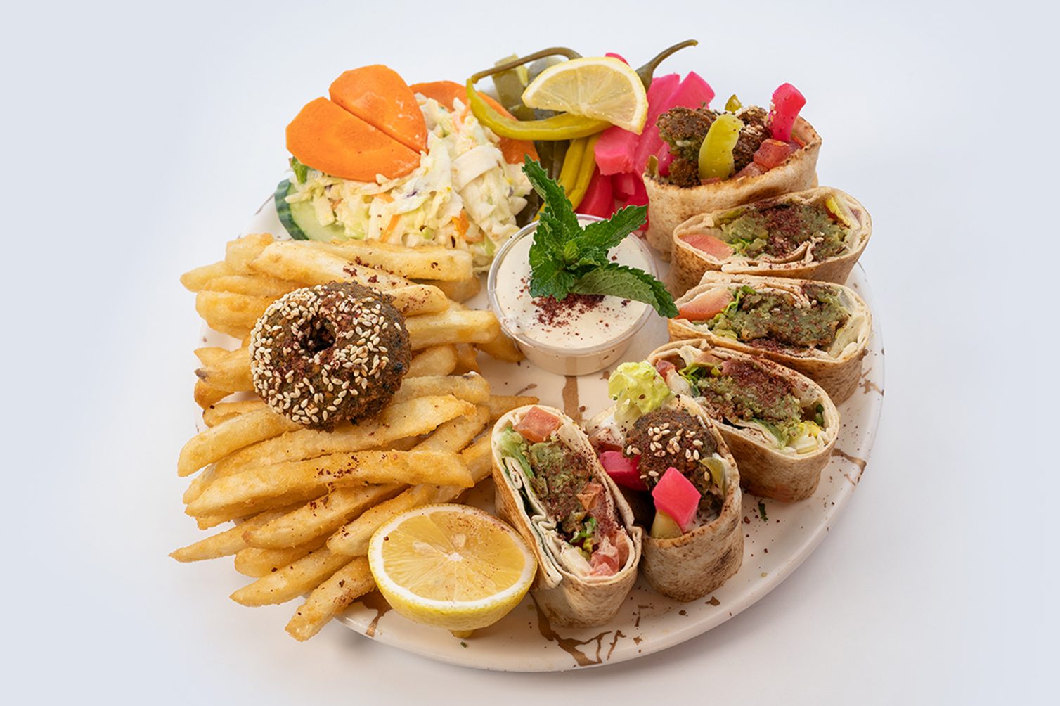 Satisfy your vegetarian cravings with Anas Vegetarian Falafel Meal. Enjoy crispy falafel paired with lettuce, tomatoes, pickles, turnips, parsley, onions, cucumbers, hummus, and tahini sauce. Complete with fries, coleslaw, pickles, turnip, and chili pepper. Explore our menu for a flavorful plant-based feast!
