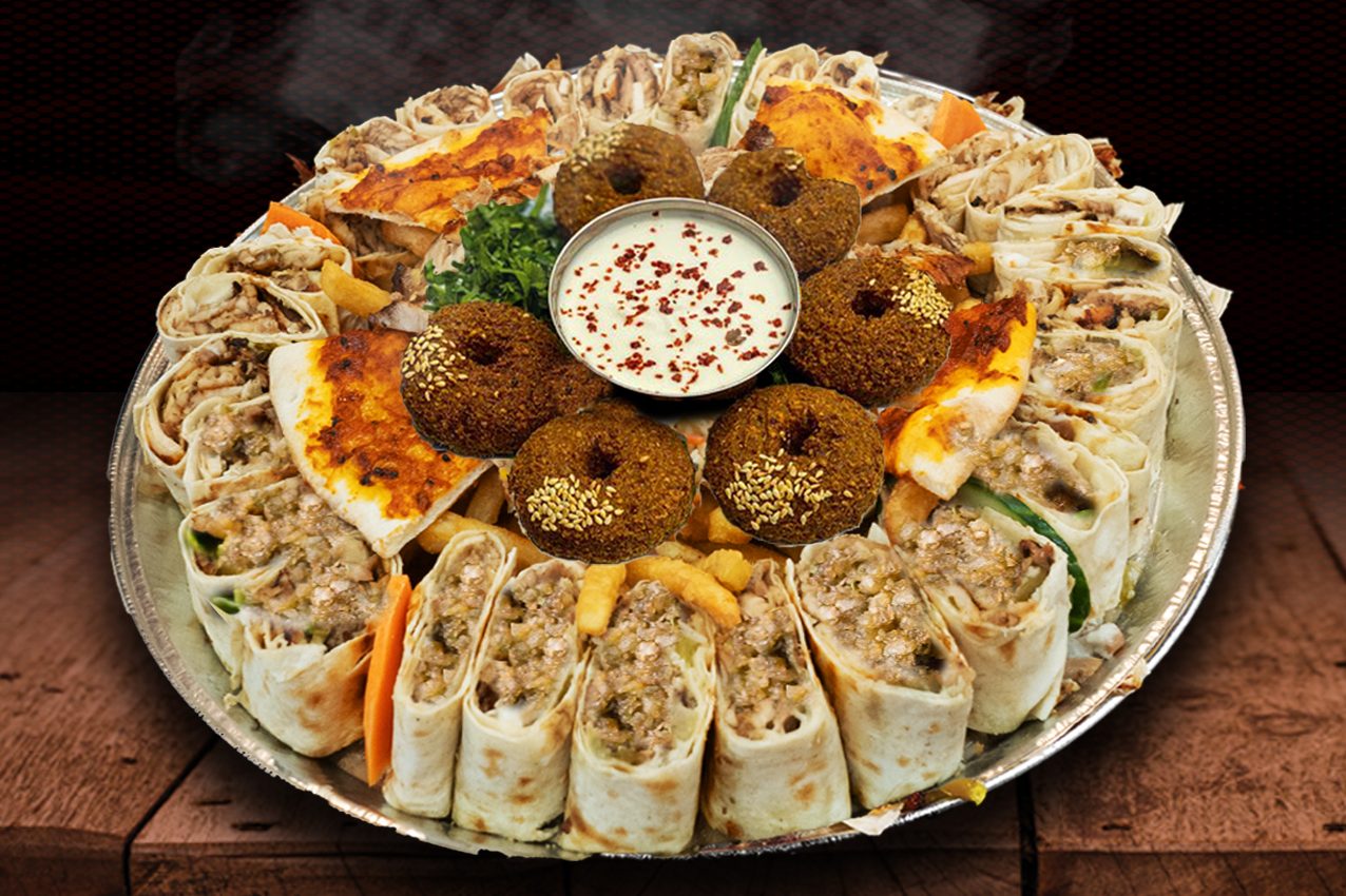 Elevate your vegetarian experience with Anas Vegetarian Falafel Family Platters. Enjoy crispy falafel paired with lettuce, tomatoes, pickles, turnips, parsley, onions, cucumbers, hummus, and tahini sauce. Served with fries, coleslaw, pickles, turnip, chili pepper, and all the sauces. Explore our menu for a delightful plant-based feast!